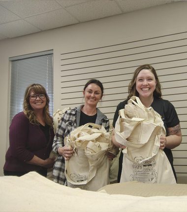 Twin Valley employees assemble bags for the summer reading program.